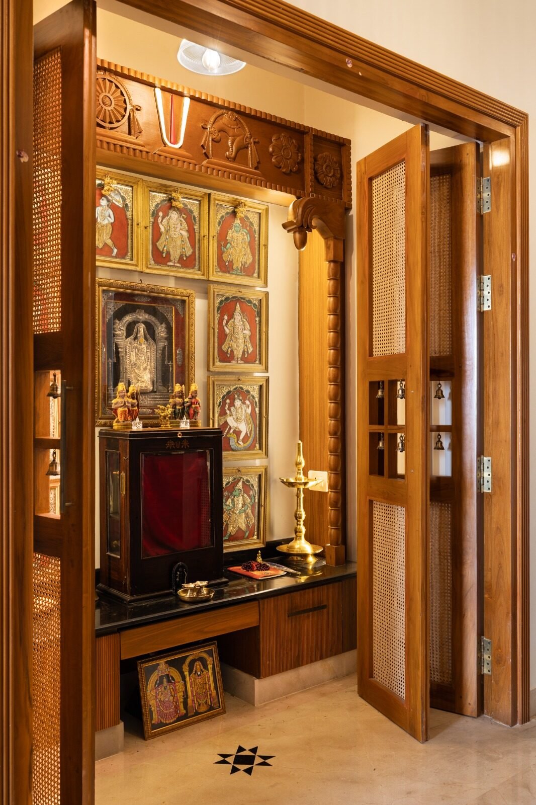 Ornate temple-inspired teak pooja unit with gold detailing
